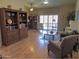 Open-concept living room featuring hardwood floors, built-in shelving and large window at 4517 E Ute St, Phoenix, AZ 85044