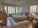 Comfortable main bedroom with hardwood floors, large windows, and a cozy reading chair at 4517 E Ute St, Phoenix, AZ 85044