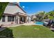 Lush backyard featuring a pool, patio with seating, and meticulously maintained landscaping at 4569 E Lariat Ln, Phoenix, AZ 85050