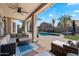 Inviting outdoor living space with comfortable seating area, pool, and well-manicured lawn at 4569 E Lariat Ln, Phoenix, AZ 85050
