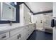 Modern bathroom with a vanity, large mirror, and a walk-in shower featuring marble tile at 4569 E Lariat Ln, Phoenix, AZ 85050