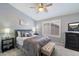 Comfortable bedroom with a ceiling fan, neutral tones, and a plush upholstered bed frame at 4569 E Lariat Ln, Phoenix, AZ 85050