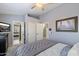 Cozy bedroom with carpet floors, a ceiling fan, and bright light from large window at 4569 E Lariat Ln, Phoenix, AZ 85050
