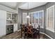Cozy dining area with a wine fridge, wooden table, and views of the pool at 4569 E Lariat Ln, Phoenix, AZ 85050
