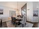 Elegant dining room featuring a large table, decorative lighting, and a neutral color palette at 4569 E Lariat Ln, Phoenix, AZ 85050
