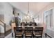 Open-concept dining room with contemporary lighting and views into the living room at 4569 E Lariat Ln, Phoenix, AZ 85050