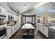 Bright kitchen with a large island, white cabinetry, modern appliances, and gray backsplash at 4569 E Lariat Ln, Phoenix, AZ 85050