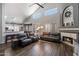 Spacious living room with vaulted ceilings, wood floors, a fireplace, and an open floor plan at 4569 E Lariat Ln, Phoenix, AZ 85050