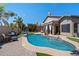 Inviting swimming pool with patio, lush landscaping, and a private outdoor living area at 4569 E Lariat Ln, Phoenix, AZ 85050