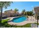 Landscaped backyard featuring a private pool, seating area, and lush greenery at 4569 E Lariat Ln, Phoenix, AZ 85050
