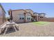 Spacious backyard featuring a picnic table, desert landscaping, and patch of synthetic grass at 4607 S Venus --, Mesa, AZ 85212