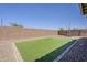 Backyard showcases block wall and a rectangular patch of synthetic grass and desert landscaping at 4607 S Venus --, Mesa, AZ 85212