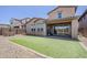 View of backyard with a block wall, desert landscaping, and patch of synthetic grass at 4607 S Venus --, Mesa, AZ 85212