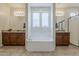 Bright bathroom boasts dual vanities, granite counters, a soaking tub, and a separate shower at 4607 S Venus --, Mesa, AZ 85212
