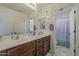 Bathroom with dual sinks, a large mirror, and nautical decor, offering a fresh and vibrant feel at 4607 S Venus --, Mesa, AZ 85212