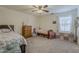 Bright bedroom showcasing two cozy beds, a ceiling fan, and a window, perfect for restful nights at 4607 S Venus --, Mesa, AZ 85212