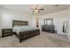 Cozy bedroom with carpet, ceiling fan, dark wood furniture and ample natural light at 4607 S Venus --, Mesa, AZ 85212