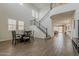Open-concept space featuring a wrought iron staircase, an adjacent dining space, and lots of natural light at 4607 S Venus --, Mesa, AZ 85212
