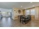 A spacious dining room with an over-sized decorative wall clock and wood-look tile flooring at 4607 S Venus --, Mesa, AZ 85212