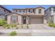 Charming two-story home featuring a tile roof and a welcoming front yard with desert landscaping at 4607 S Venus --, Mesa, AZ 85212