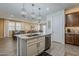 Modern kitchen with an island, pendant lighting, and seamless flow to the dining and living areas at 4607 S Venus --, Mesa, AZ 85212