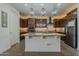 A modern kitchen with wooden cabinets, stainless steel appliances, and granite countertops on the island at 4607 S Venus --, Mesa, AZ 85212