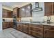 Gourmet kitchen with stainless steel appliances, dark wood cabinets, granite countertops and a modern gas range at 4607 S Venus --, Mesa, AZ 85212