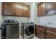 Laundry room showcasing wood cabinets, sink, and gray Samsung washer and dryer at 4607 S Venus --, Mesa, AZ 85212