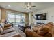A spacious living room featuring an entertainment area, leather couches, and a sliding glass door at 4607 S Venus --, Mesa, AZ 85212