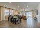 A spacious living room with a dining area and leather sofas, next to a sliding glass door at 4607 S Venus --, Mesa, AZ 85212