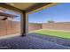 View of covered patio and backyard featuring pavers, rock, and a patch of synthetic grass at 4607 S Venus --, Mesa, AZ 85212