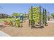 View of the green and blue playground with climbing structures and wooden chairs at 4607 S Venus --, Mesa, AZ 85212