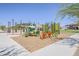 Playground featuring play equipment and seating surrounded by grassy areas and sidewalks at 4607 S Venus --, Mesa, AZ 85212
