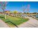 Scenic pond view with lush green grass, mature trees, and walking path, perfect for relaxing at 4607 S Venus --, Mesa, AZ 85212