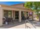 Covered back patio with BBQ grill, seating, and access to the backyard and pool area at 7008 W Southgate Ave, Phoenix, AZ 85043