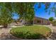 Lush backyard with beautiful desert landscaping features a pool, a spa, and a covered patio at 7008 W Southgate Ave, Phoenix, AZ 85043