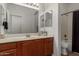 Bright bathroom with modern fixtures, a large mirror, and a shower-tub combination at 7008 W Southgate Ave, Phoenix, AZ 85043