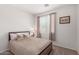 The well lit bedroom has neutral tones, framed art and a comfortable bed at 7008 W Southgate Ave, Phoenix, AZ 85043