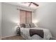 A well lit bedroom featuring a comfortable bed and neutral tones at 7008 W Southgate Ave, Phoenix, AZ 85043