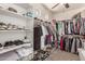 A spacious walk-in closet featuring custom shelving and hanging rods for optimal storage at 7008 W Southgate Ave, Phoenix, AZ 85043