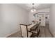 Formal dining room with modern chandelier and seating for four at 7008 W Southgate Ave, Phoenix, AZ 85043