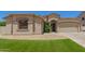Charming home featuring a well-manicured lawn and a two-car garage, offering curb appeal and convenience at 7008 W Southgate Ave, Phoenix, AZ 85043