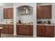 Kitchen features granite countertops, stainless steel appliances, and warm cabinetry at 7008 W Southgate Ave, Phoenix, AZ 85043