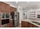 Modern kitchen with stainless steel appliances, granite counters, and ample storage at 7008 W Southgate Ave, Phoenix, AZ 85043