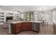 Open-concept kitchen with island seating and connecting living and dining area at 7008 W Southgate Ave, Phoenix, AZ 85043