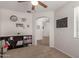 Cozy living room with built-in bookshelves, neutral carpet, and a view into the next room at 7008 W Southgate Ave, Phoenix, AZ 85043