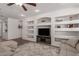 Spacious living room with built-in shelves, modern decor, and neutral colors at 7008 W Southgate Ave, Phoenix, AZ 85043