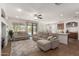 Open-concept living room with plush seating, tile flooring, and pool views at 7008 W Southgate Ave, Phoenix, AZ 85043