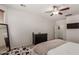 This well-lit primary bedroom features neutral walls and a dark wood dresser and mirror at 7008 W Southgate Ave, Phoenix, AZ 85043