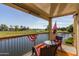 Balcony view overlooking a lake and golf course; furnished with a table and chairs at 7101 W Beardsley Rd # 422, Glendale, AZ 85308